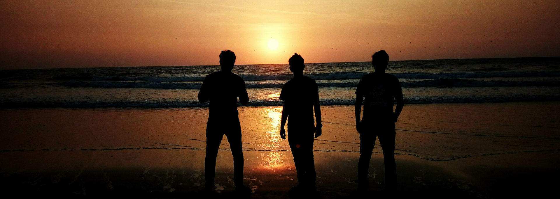 Picture of a group of people standing on quiet part of a beach. Picture of a group of people standing on quiet part of a beach.