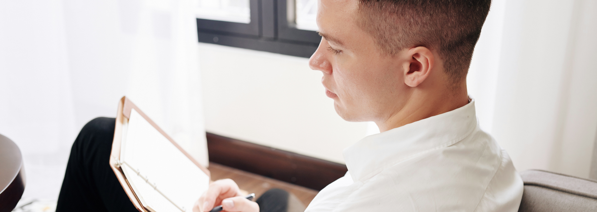 Picture of a person sitting down, looking thoughtful.