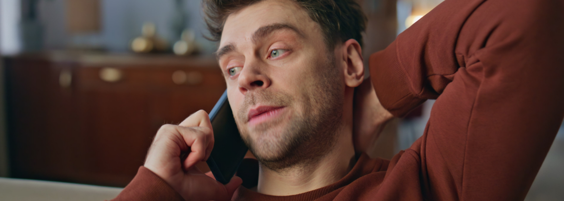 Picture of somebody on the phone looking lightly relieved. Picture of somebody on the phone looking lightly relieved.