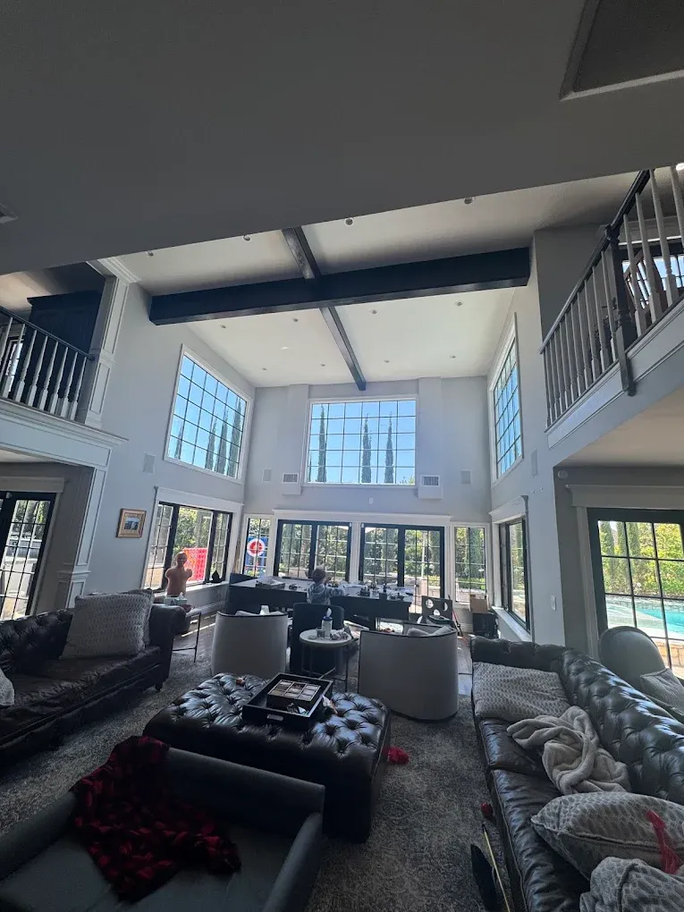 A living room filled with furniture and a lot of windows.