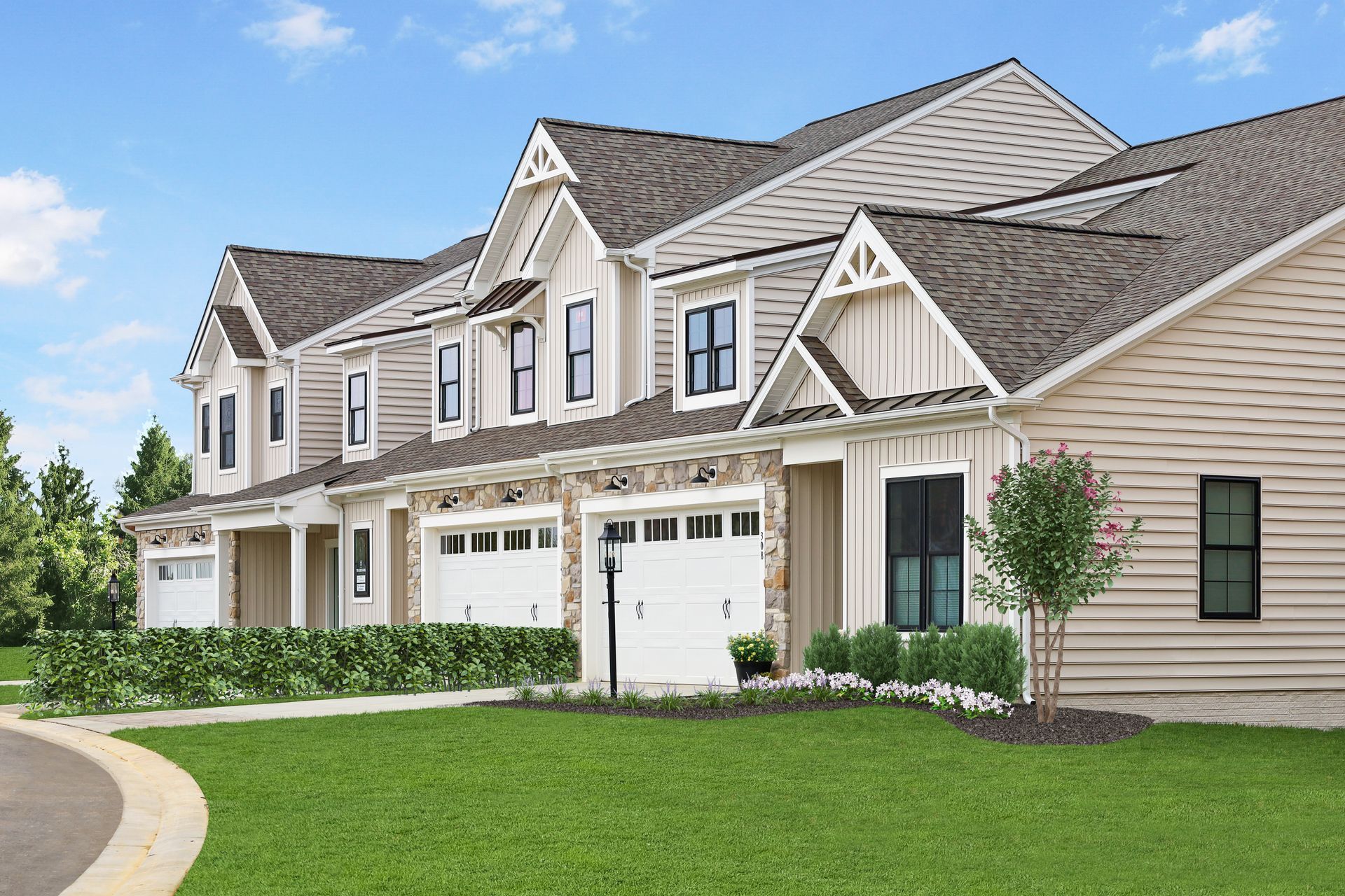 Row of modern townhouses with white garages, stone accents, and tan siding on a sunny day.