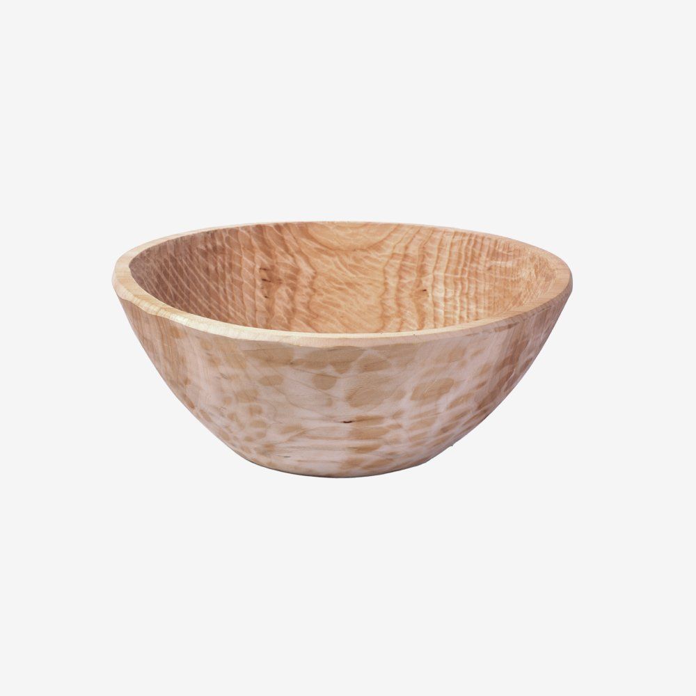 Small light wood bowl with a natural grain pattern on a white background