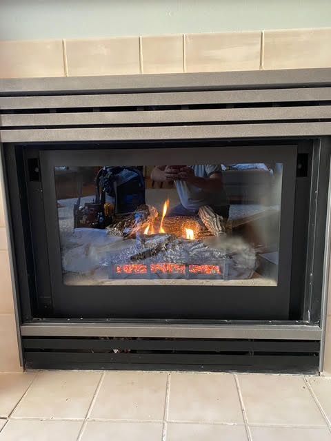 A fireplace with a white mantle in a living room.