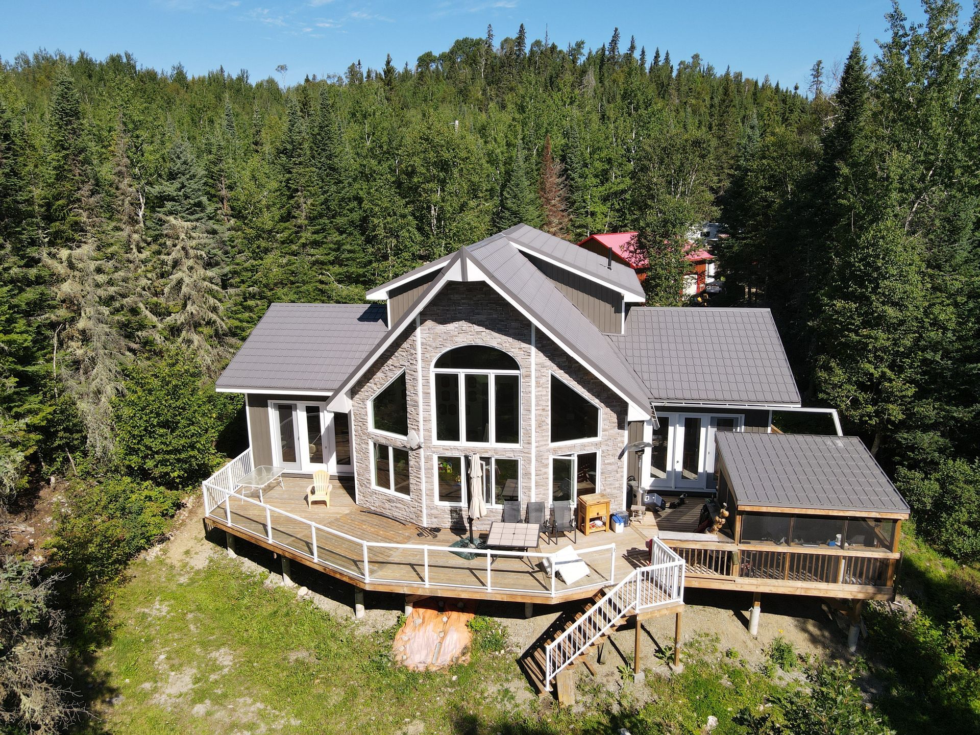An aerial view of a large house surrounded by trees