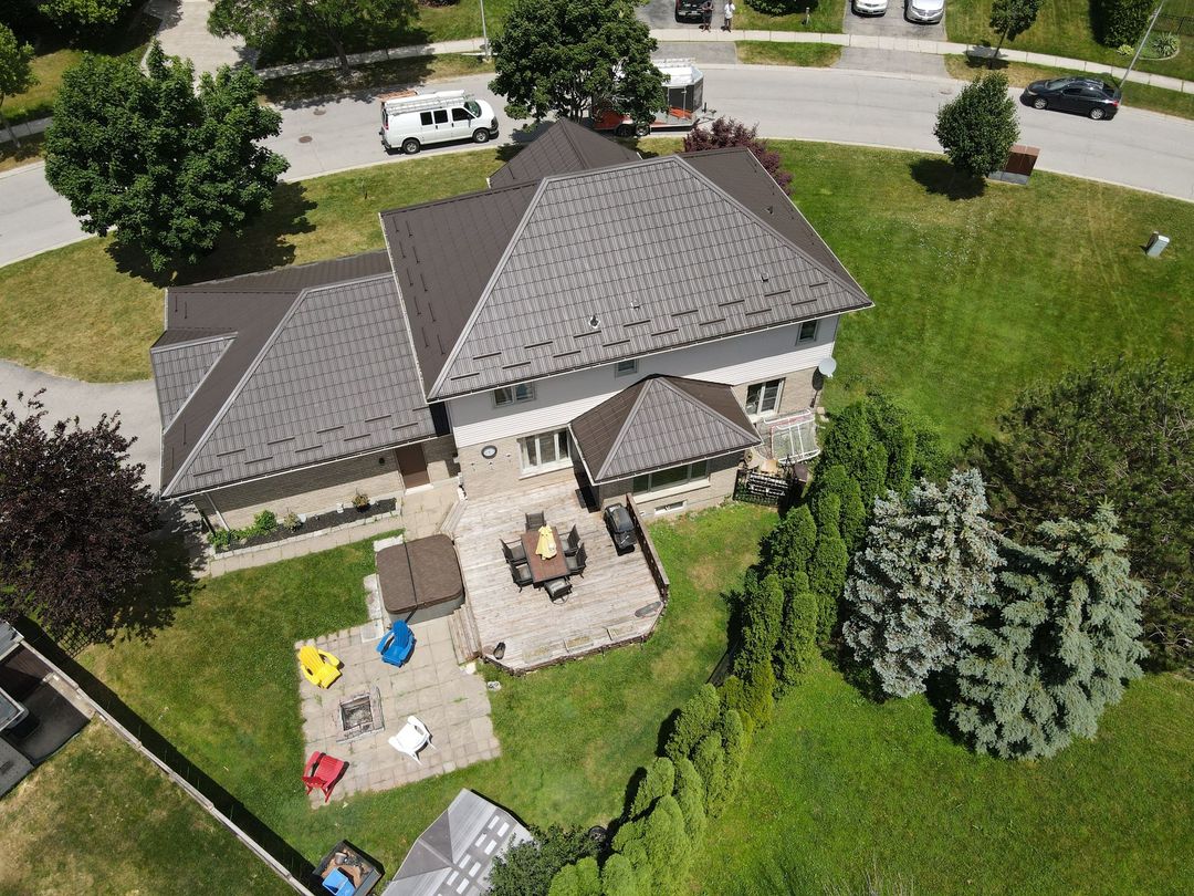 An aerial view of a house with a fire pit in the backyard
