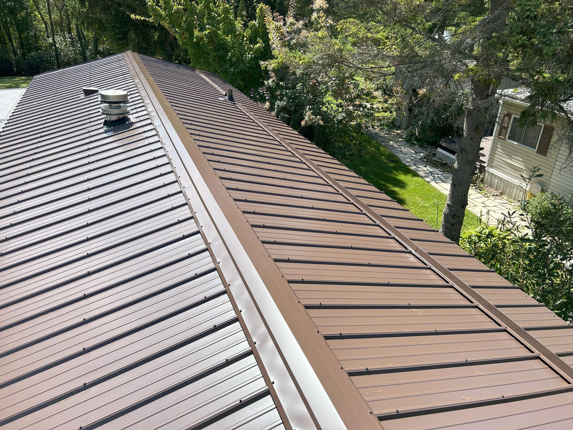 A brown roof with a chimney on top of it.