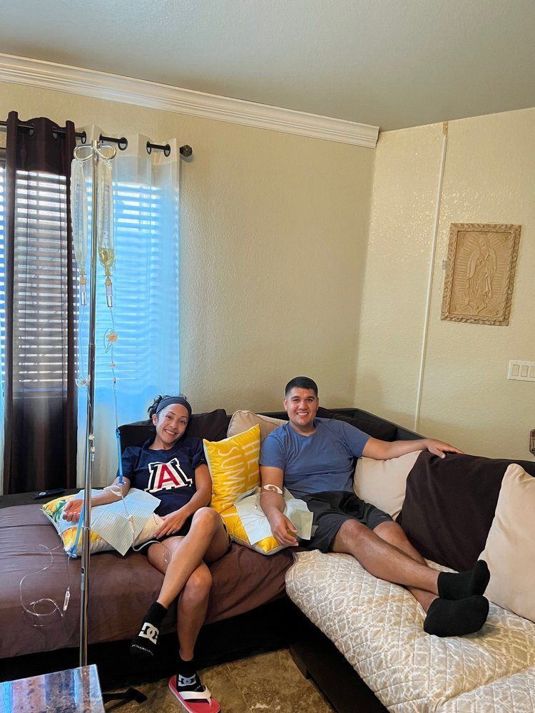 A man and a woman are sitting on a couch in a living room.