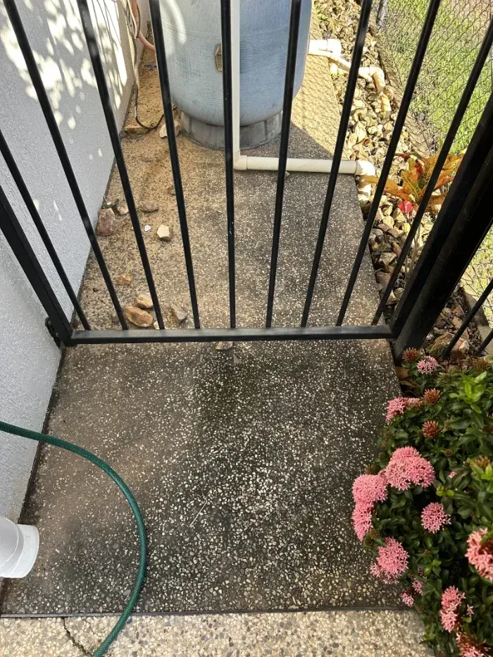Dark Metal Gate Blocks a Concrete Walkway — I Do It All in Caloundra, QLD
