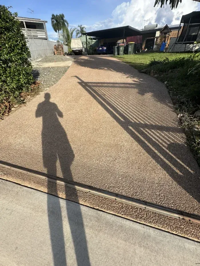 Person's Shadow Cast Over a Pebble-textured Driveway — I Do It All in Noosa, QLD