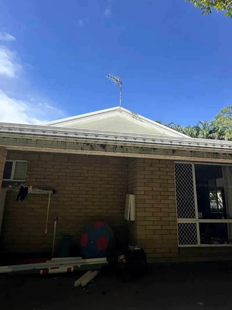 Tan Brick House With a White Roof Under a Bright Blue Sky — I Do It All in Noosa, QLD