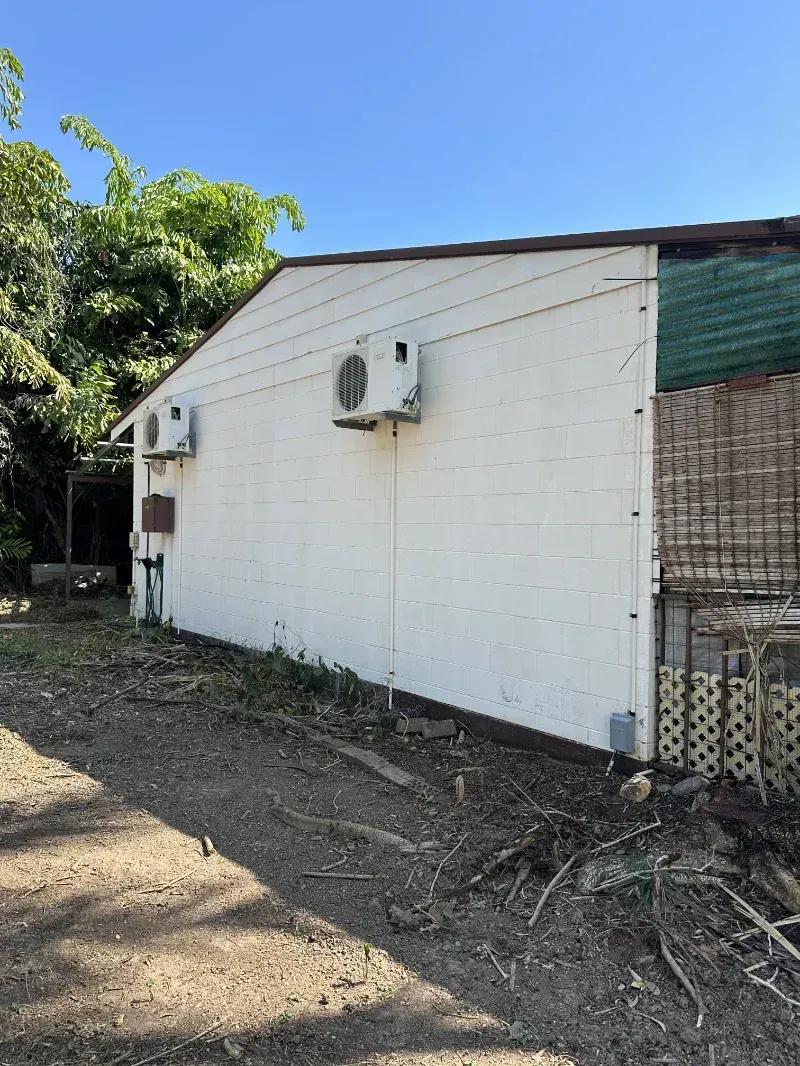 White Exterior Side Wall of A Small Building — I Do It All in Caloundra, QLD