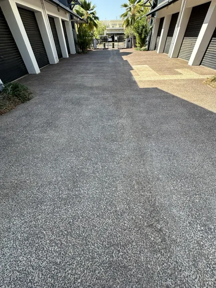 Outdoor Walkway Between Gray Buildings with Palm Trees — I Do It All in Caloundra, QLD