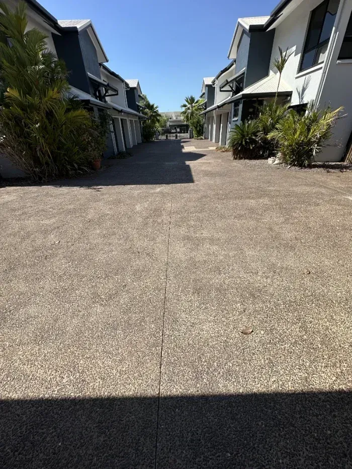 A Sunny Paved Residential Walkway Between Modern White Townhouses — I Do It All in Caloundra, QLD