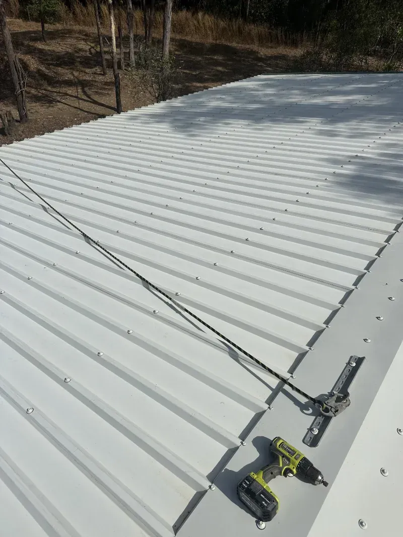 A White Corrugated Metal Roof with A Harness Rope and Tools — I Do It All in Caloundra, QLD