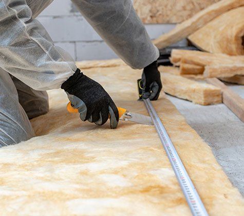 Worker Installing Thermal Insulation — Derby, KS — Dennis Insulation