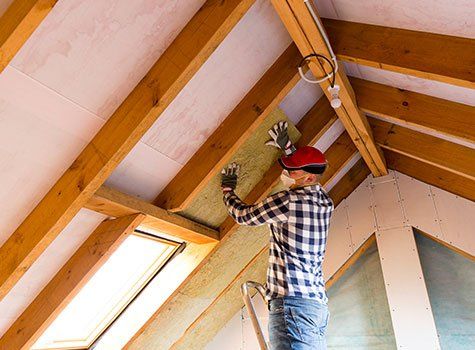 Man Installing Mineral Wool Insulation — Derby, KS — Dennis Insulation Man Installing Mineral Wool Insulation — Derby, KS — Dennis Insulation
