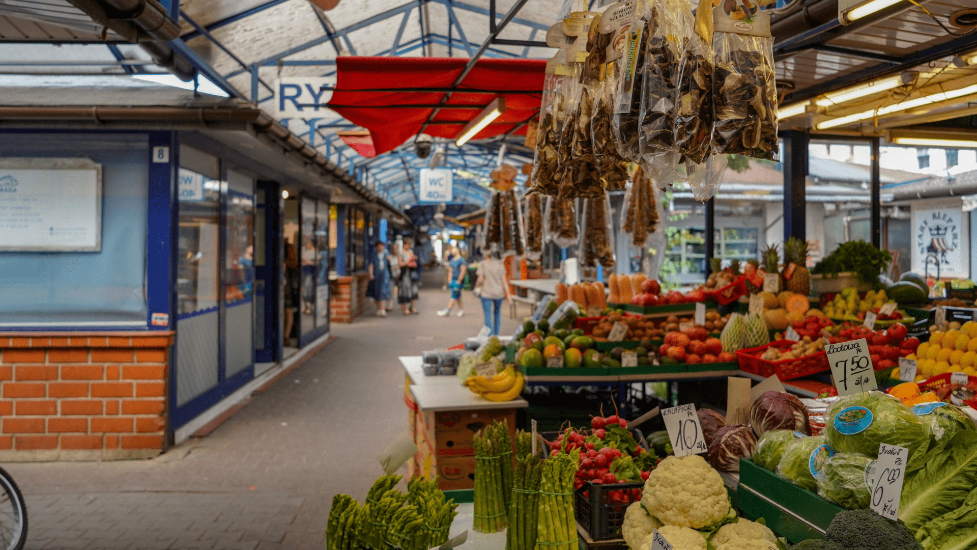 Indoor market hall with stalls selling fresh produce and goods