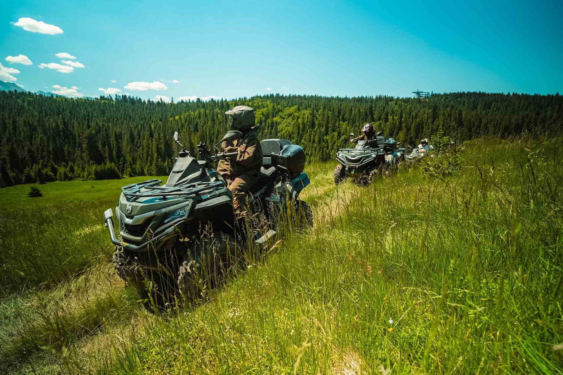 Quad rider driving on a gravel mountain trail in the Tatra area near Krakow.