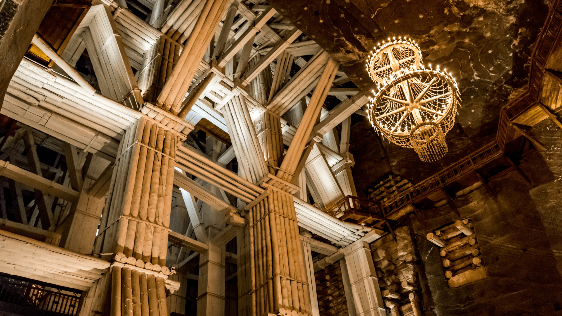 Underground wooden structure and chandelier inside Wieliczka Salt Mine.