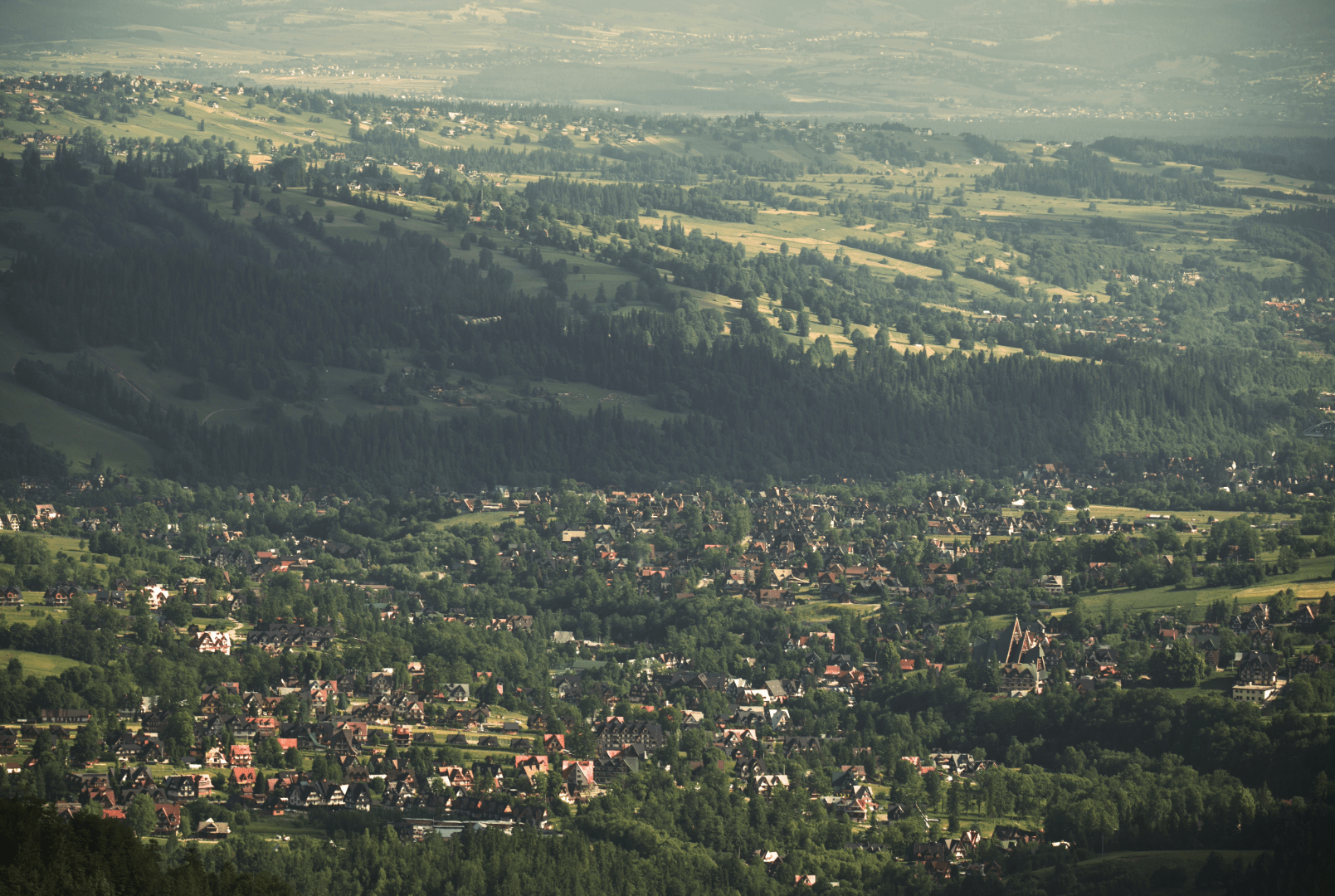 Aerial view of Zakopane town nestled among forests and mountains
