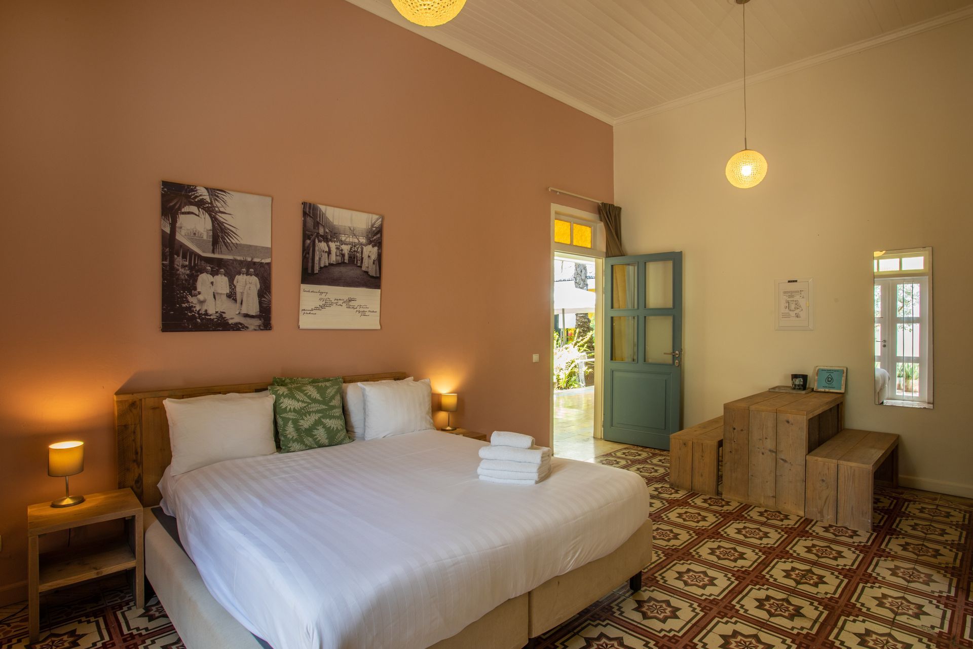 There is a large bed in the middle of the room. t Klooster Hotel Curacao