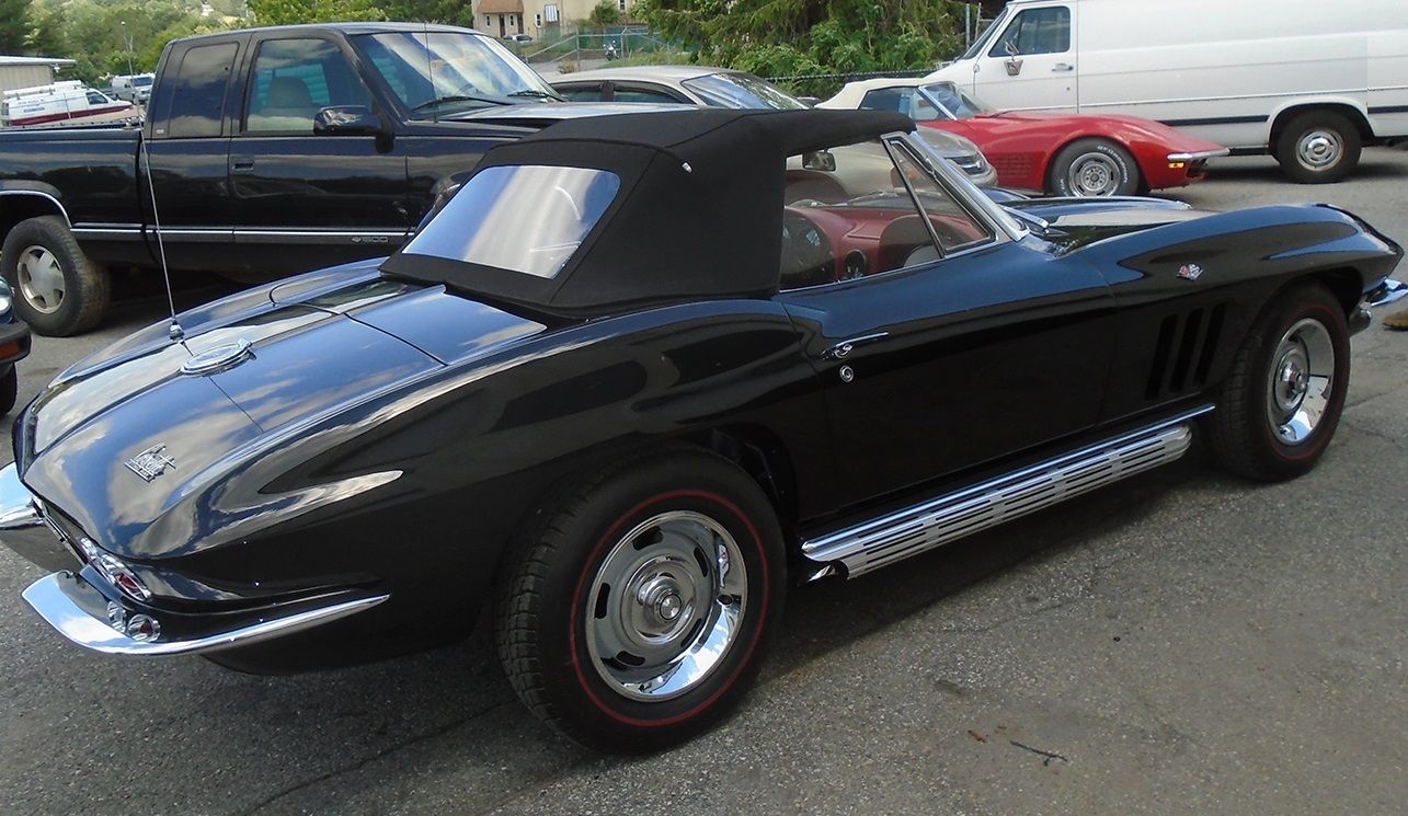 Black convertible classic car parked outdoors.