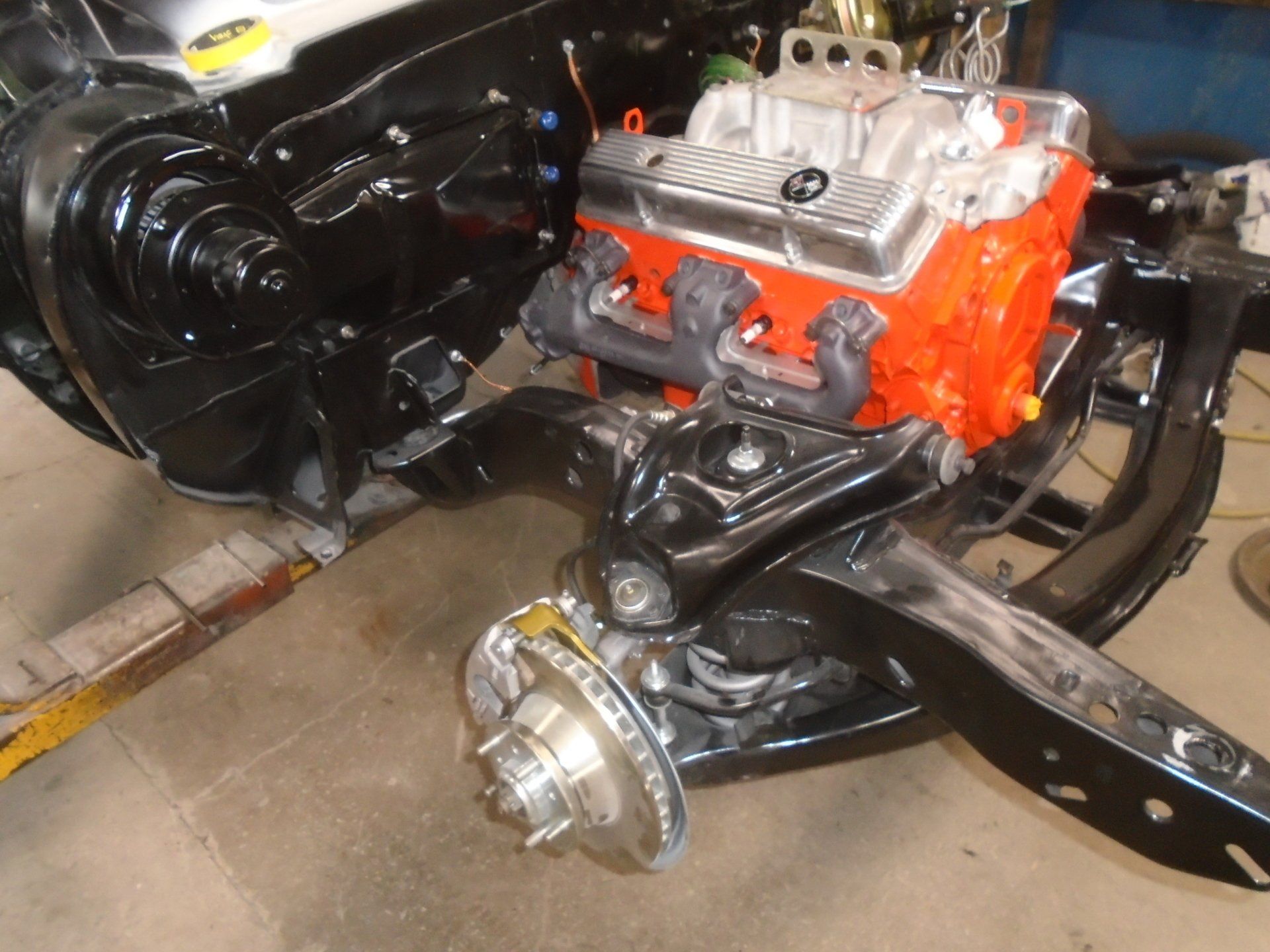 Black car chassis with orange engine and silver valve covers.