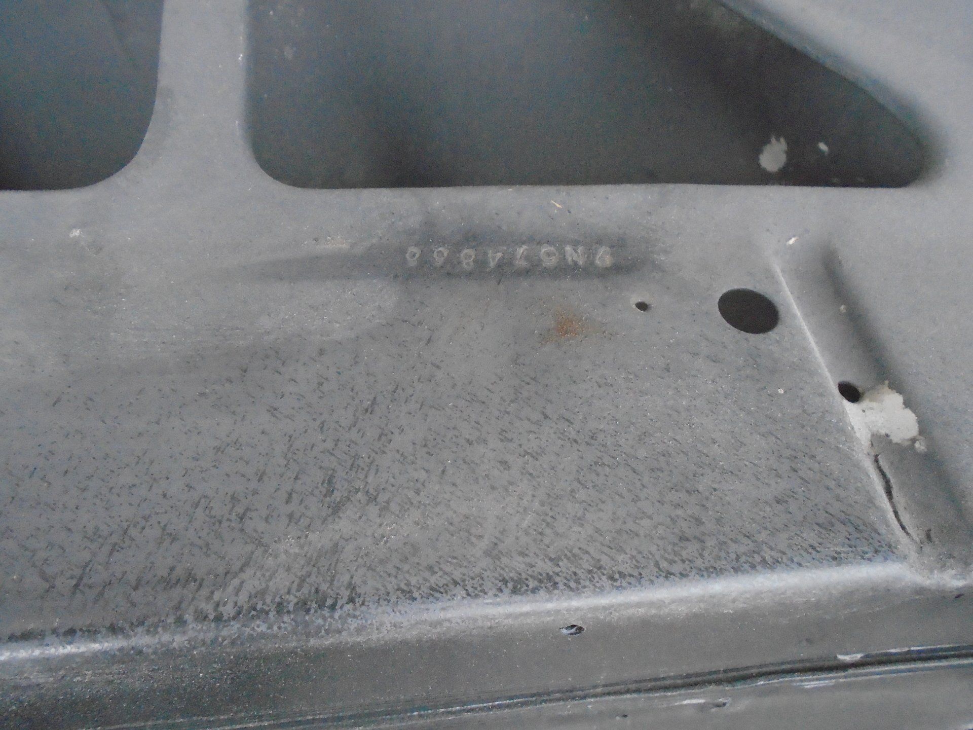 Close-up of a metal surface with the stamped number 