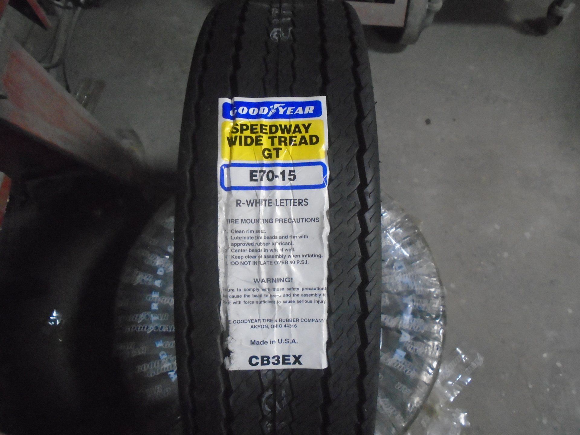 Goodyear Speedway Wide Tread GT tire, E70-15 size, on a rim, indoors.