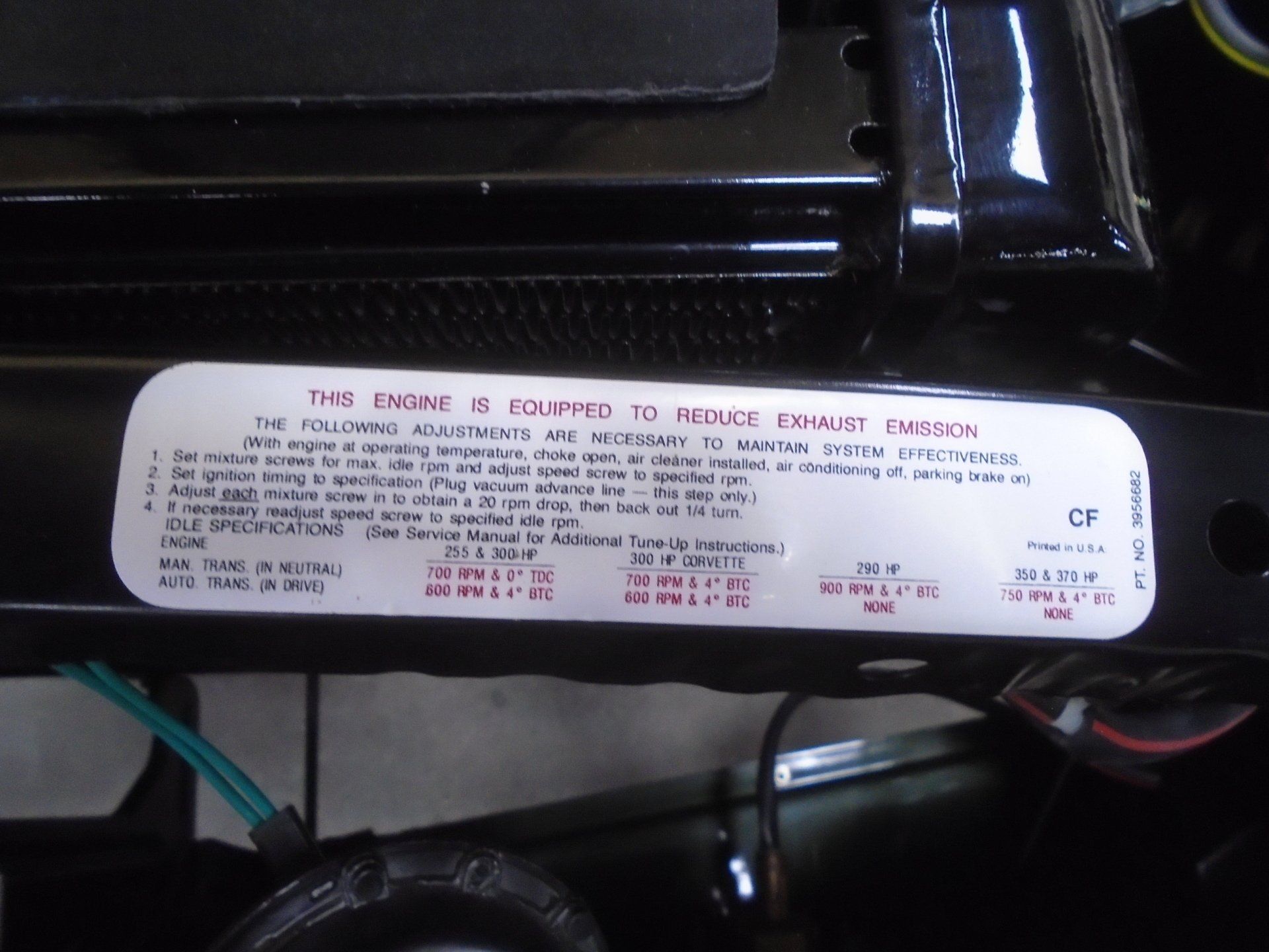 Engine compartment sticker with adjustment instructions, temperatures, and specifications.