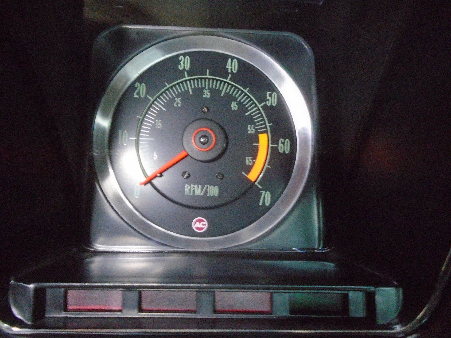 Tachometer displaying 60 RPM, with red needle. Below, three rectangular lights. Silver trim.