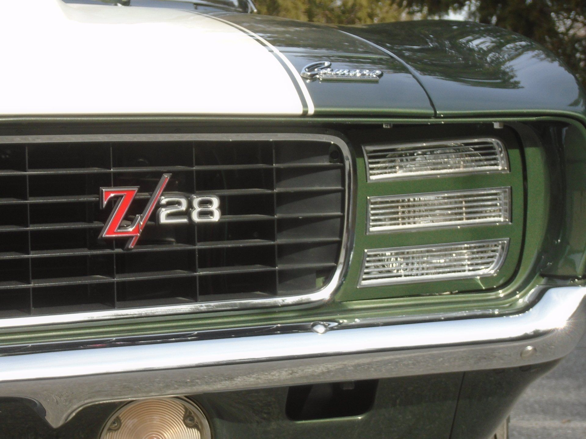 Green and white 1969 Chevrolet Camaro Z/28 car front, grille, headlights, and 