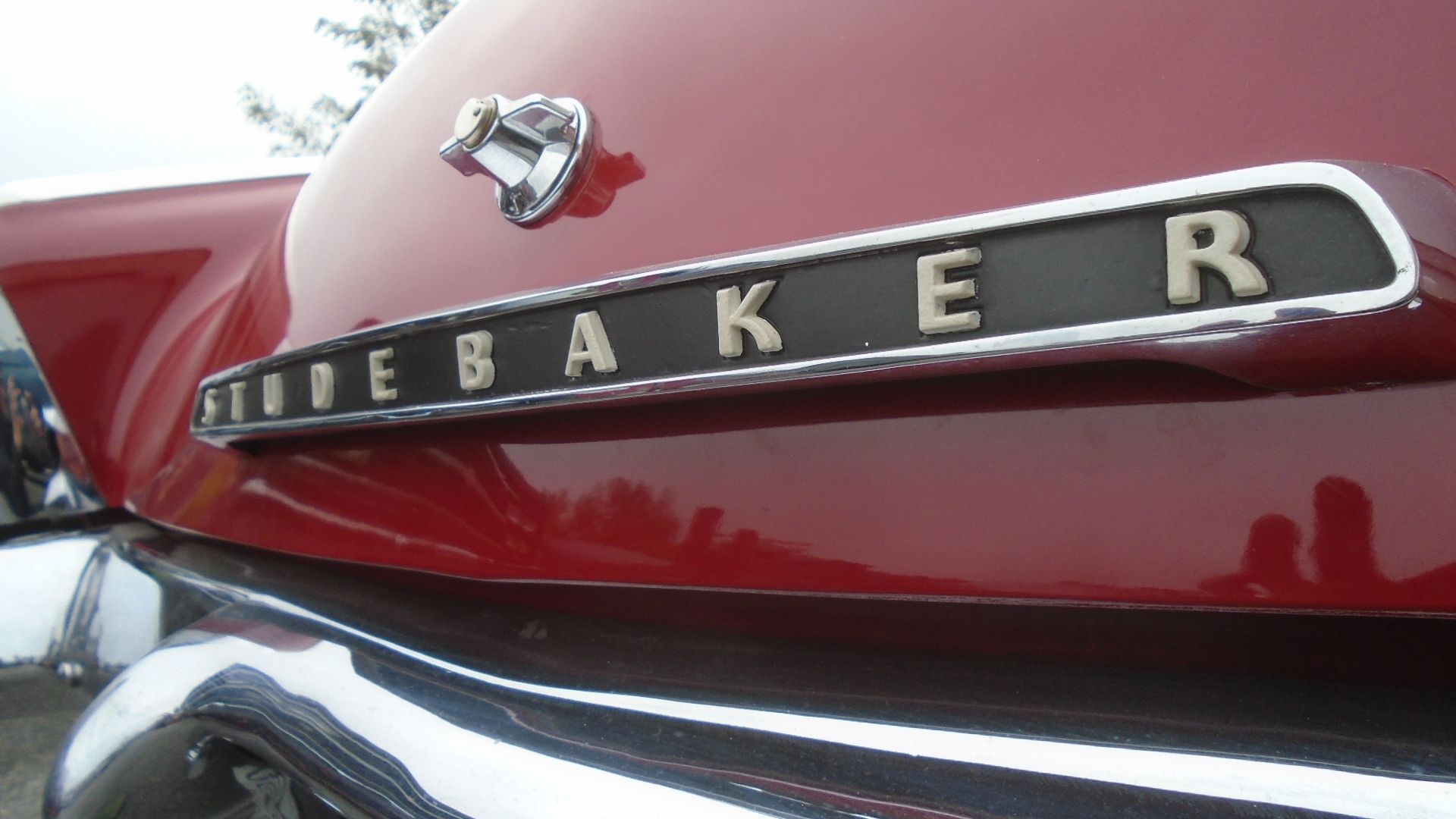 Red car with chrome trim; 