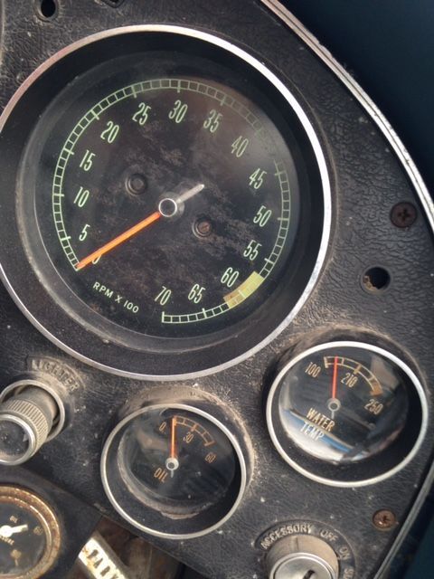 Dashboard gauges, including a tachometer at approximately 3000 RPM, and an oil temperature gauge.