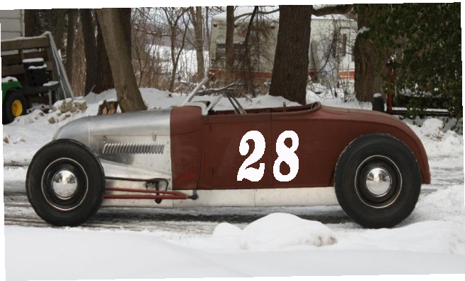 Vintage racing car, number 28, with a silver front and maroon body, parked in the snow.