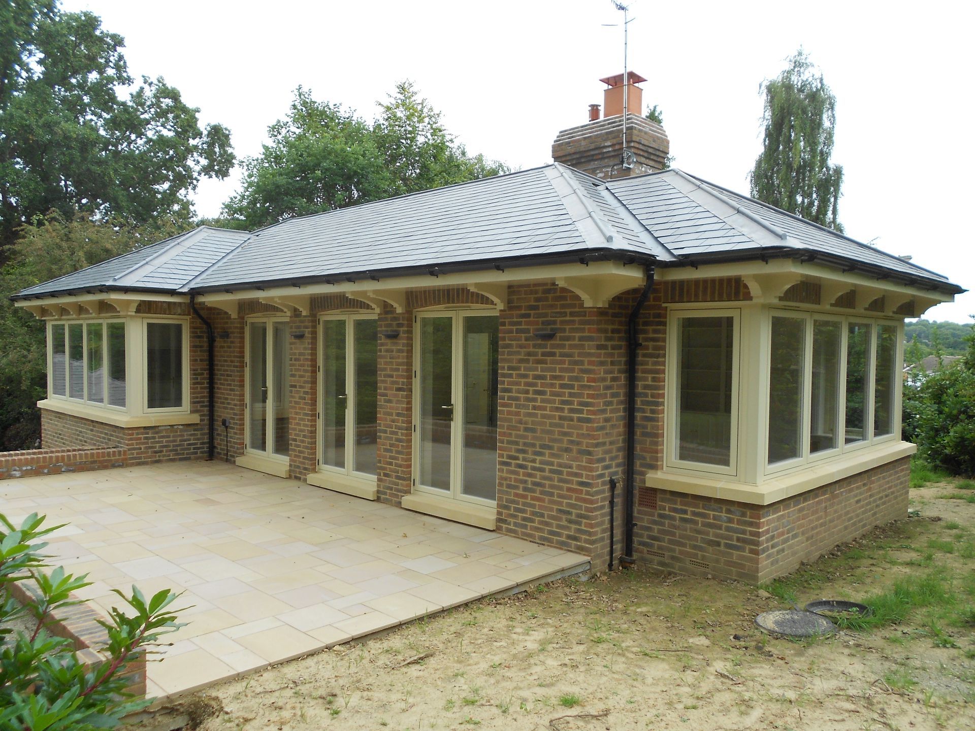 cream wood windows and French doors on a home in Sussex