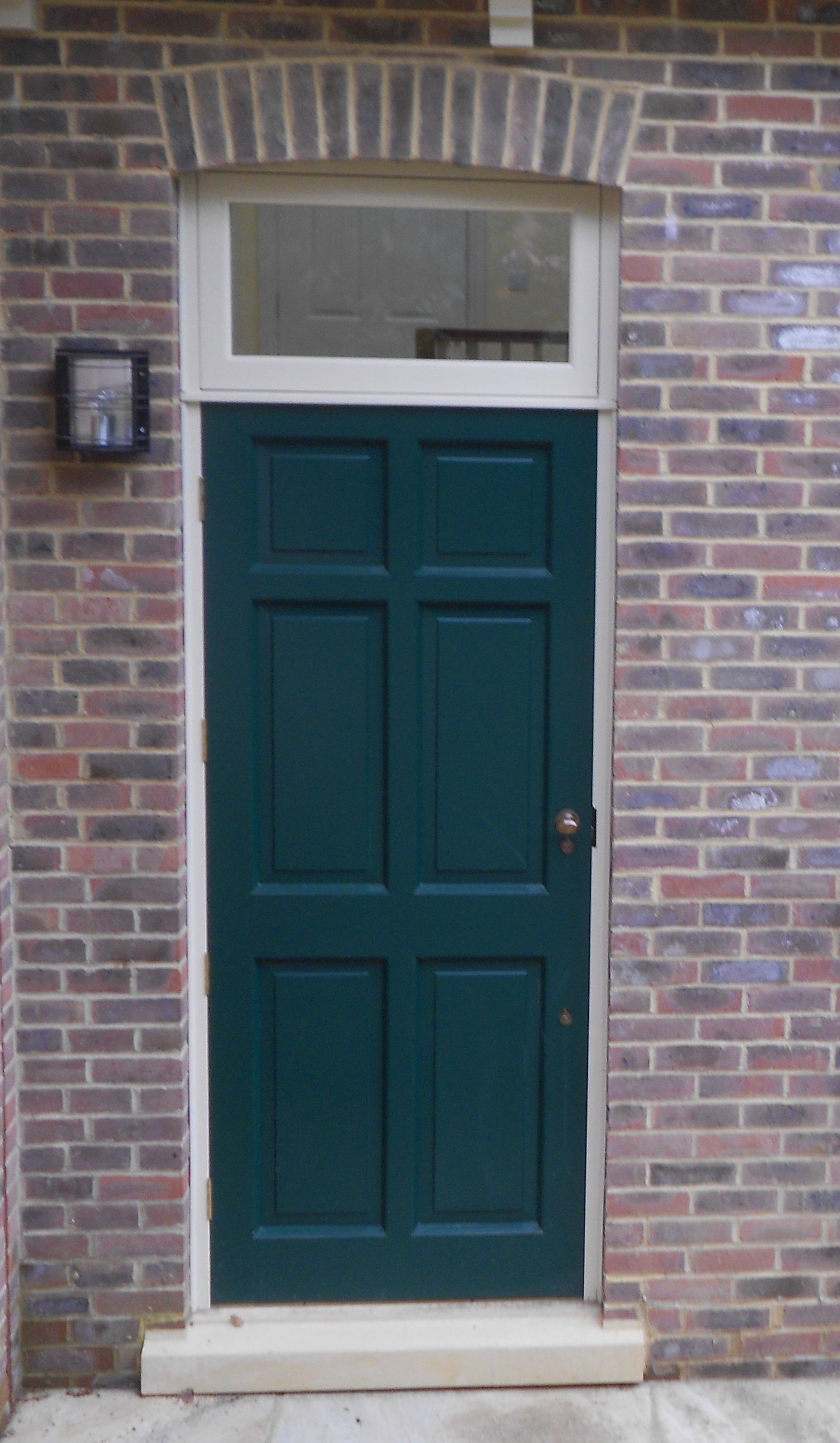 green wood door installed in Sussex