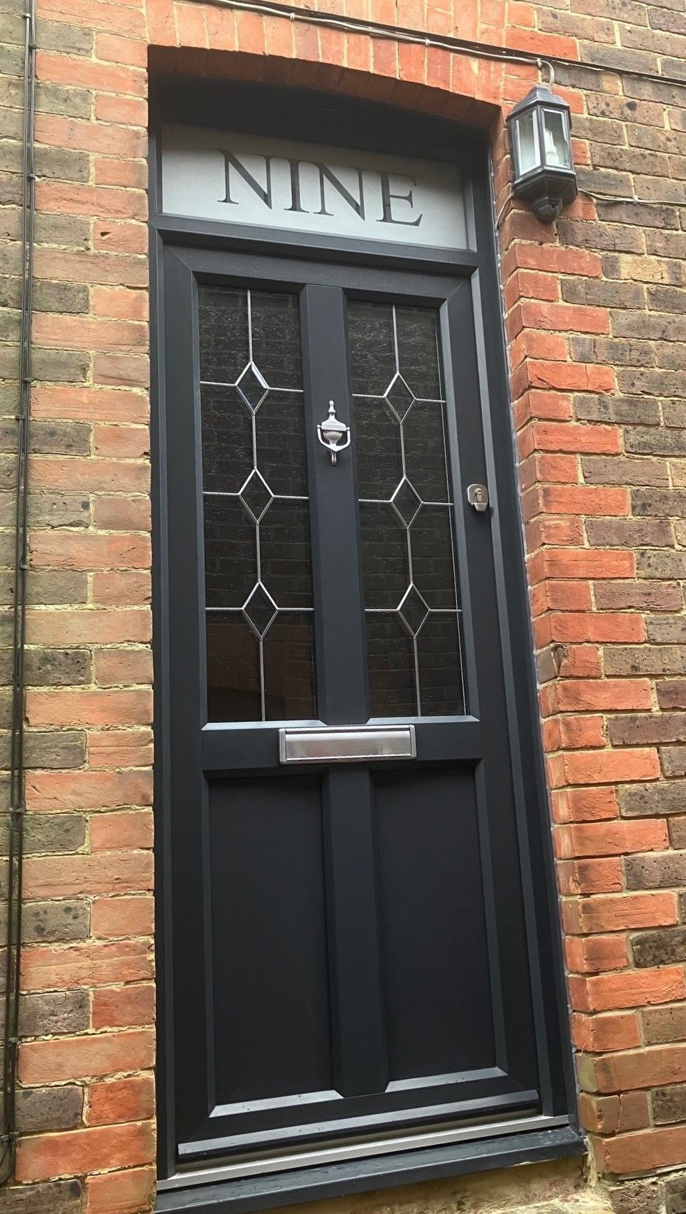 black pvc door with number above