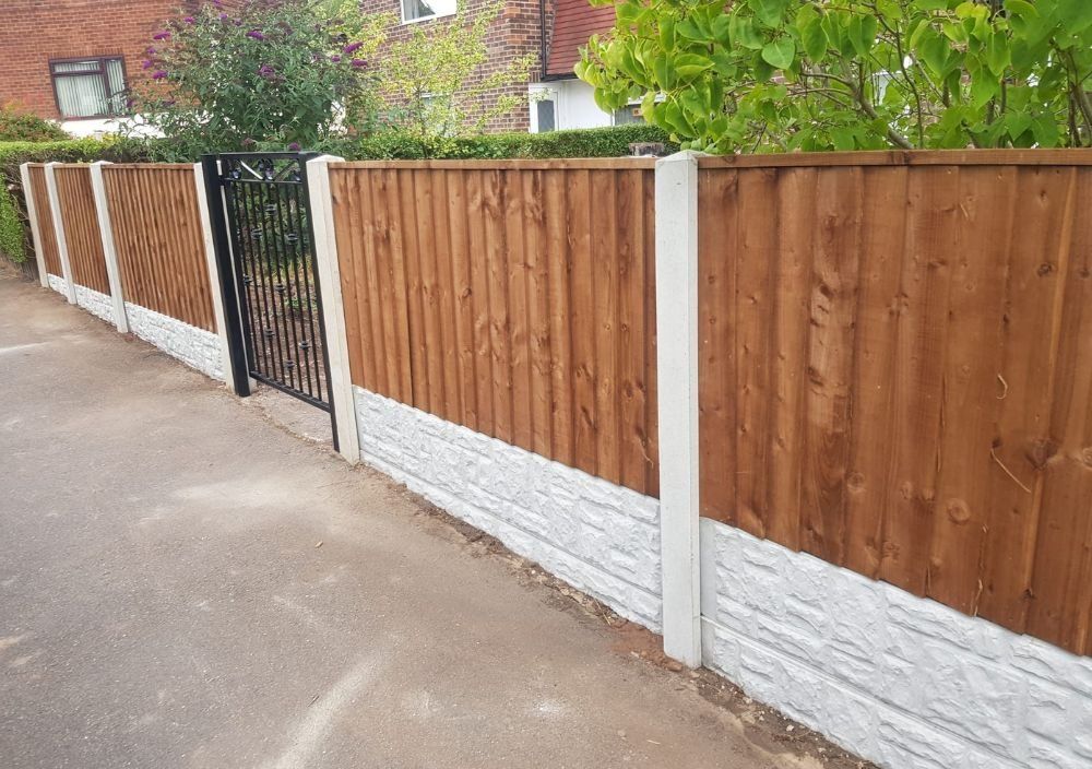 Closeboard timber front fence with concrete posts, gravel boards and a black metal gate