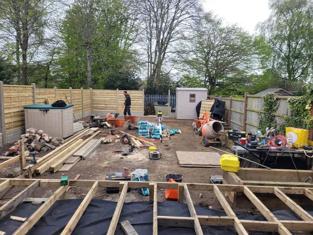 Wyken garden during the build with the old deck boards lifted and new fencing going in