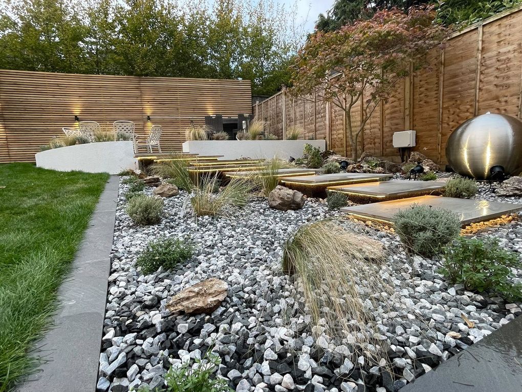 Close view of rocks, ornamental grasses, lavender and decorative stone around the floating steps