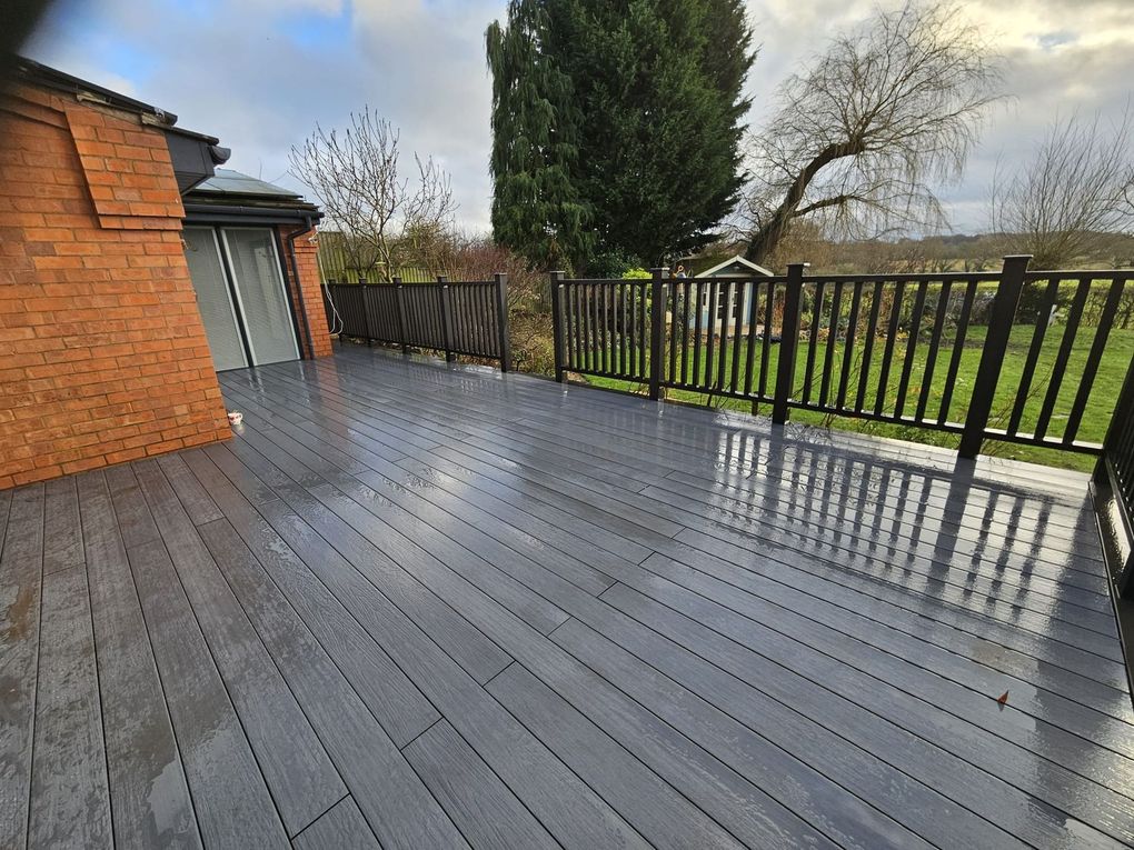 Grey composite deck with railings looking out over open land