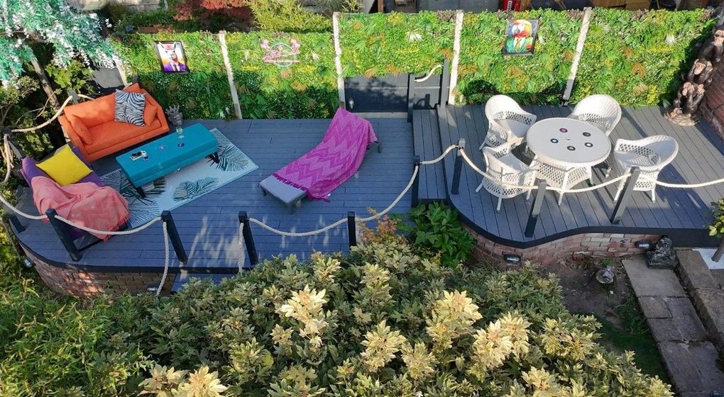 View from above of the finished Galley Common composite deck on two levels with rope balustrade, outdoor seating and dining furniture