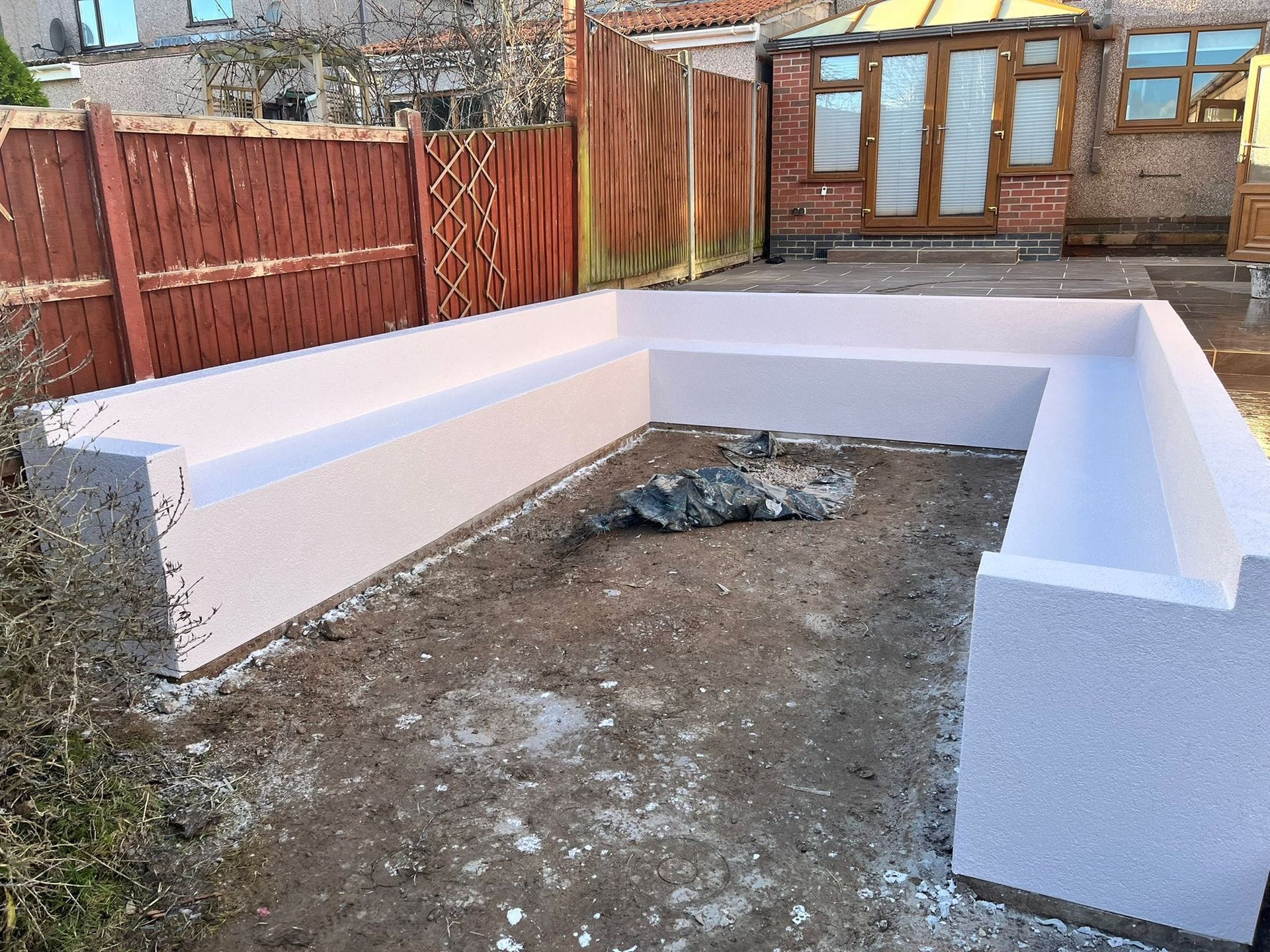 DNA Landscapes rendered garden wall with seating in Coventry