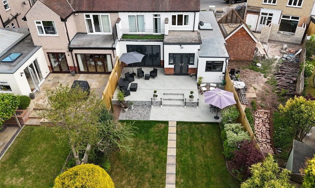 Drone view of the finished Earlsdon garden showing the new terrace across the back of the house and the lawn and path running down the plot
