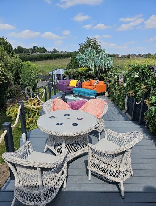 Dining area on a raised composite deck with rope balustrade and green wall panels in Galley Common, Nuneaton