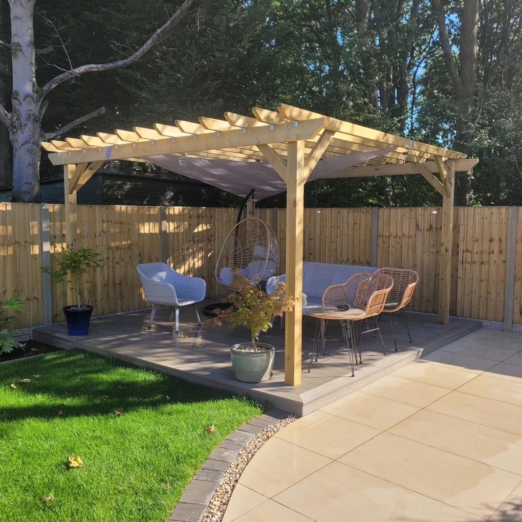 Timber pergola over a porcelain patio with outdoor seating beside a new lawn