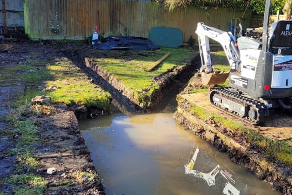 DNA Landscapes French drainage trenches being installed in clay soil in Solihull