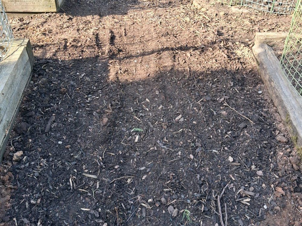 Bed dressed with screened topsoil after drainage trenches were backfilled and covered
