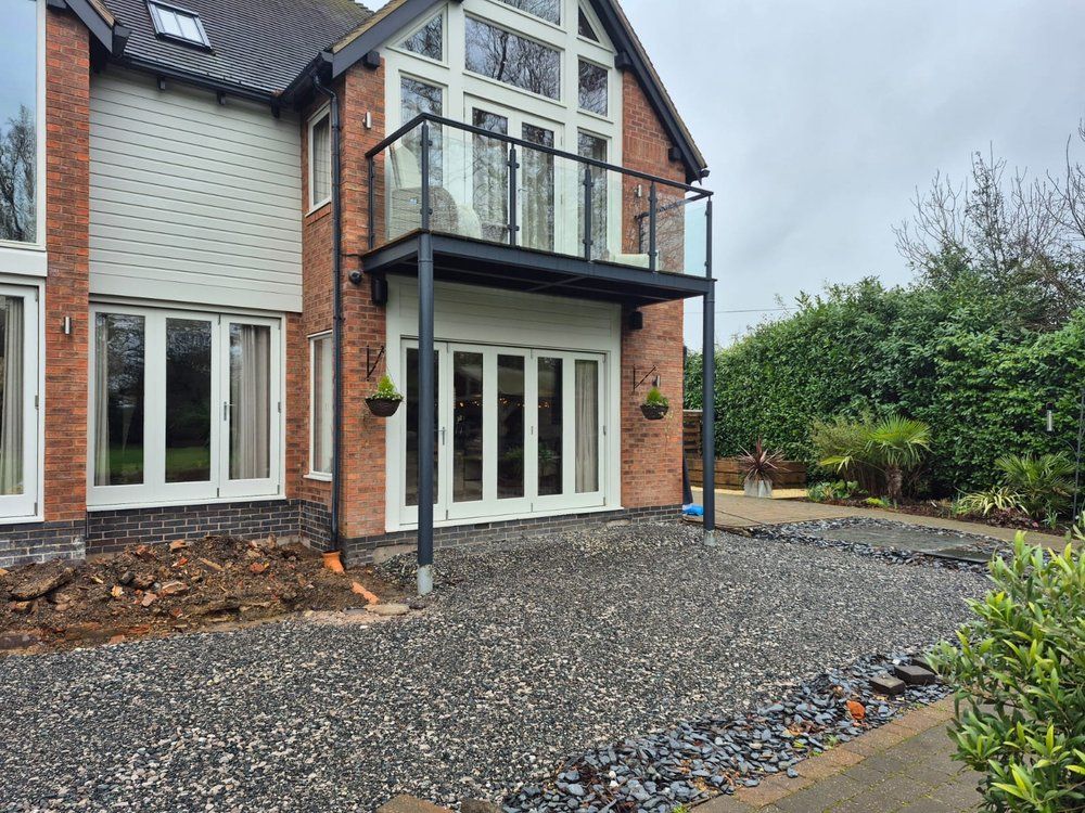 Bare gravel and exposed subsoil across the rear of Chestnut House in Lapworth before landscaping began